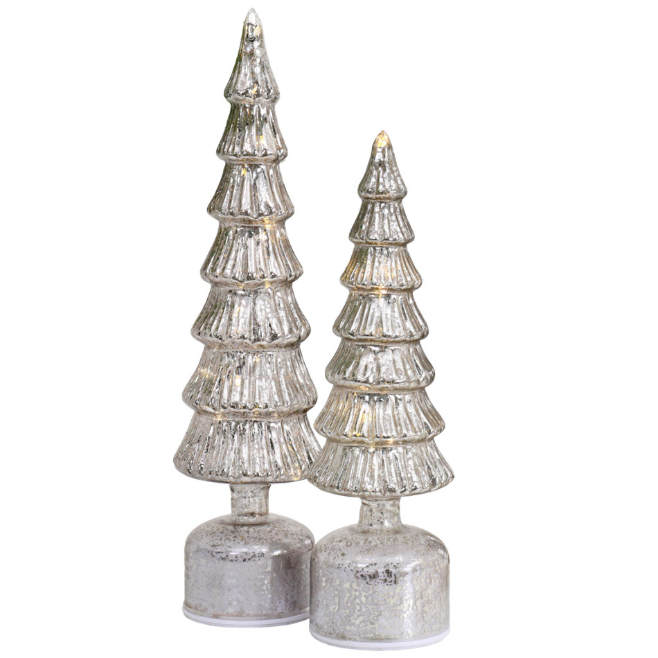 Small Wonderland silver Christmas tree beside the coordinating large tree, both illuminated against a white background