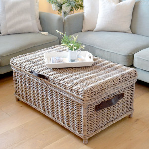 Hartley rattan storage trunk styled as a coffee table in front of a sofa
