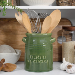 Green ceramic Cucina utensil holder filled with wooden spoons and whisks on a kitchen bench