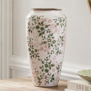 Tall Evergreen floral ceramic vase styled empty on a timber console beside books and a green dish