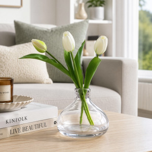 Monet clear glass vase with three white tulips styled on a living room coffee table