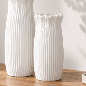 Short Marissa white fluted ceramic vase with a frilled rim beside the taller matching vase on a timber console