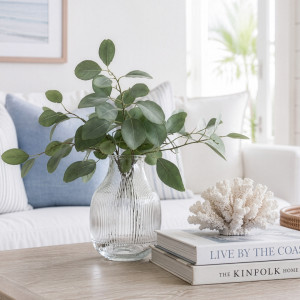 Ribbed clear glass vase with eucalyptus styled on a coastal living room coffee table