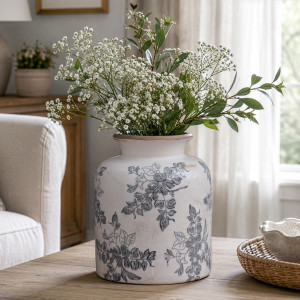 Short Norwood grey floral vase holding white flowers and greenery in a softly lit living room