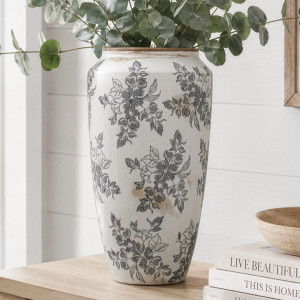 Tall Norwood grey floral ceramic vase filled with eucalyptus on a timber console beside stacked books
