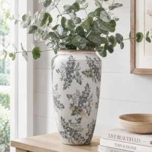 Tall Norwood grey floral vase filled with eucalyptus and styled beside books in a neutral room