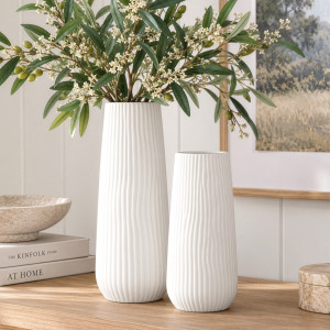 Short and tall Zahra white vases on a timber console, with olive stems in the tall vase and artwork behind