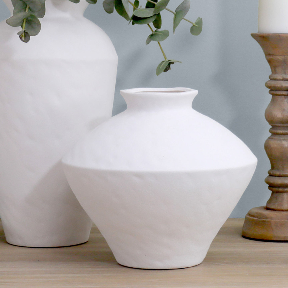 Wide white matt angular ceramic vase displayed with a taller matching vase, eucalyptus stems and a wooden candle holder.