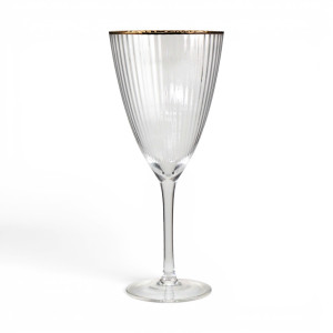 Single clear ribbed wine glass with a gold-coloured rim, tall stem and round foot against white