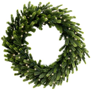 Forest Glow Christmas wreath with layered green artificial pine foliage and glowing lights against white